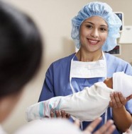 Physician Handing Newborn to Mother